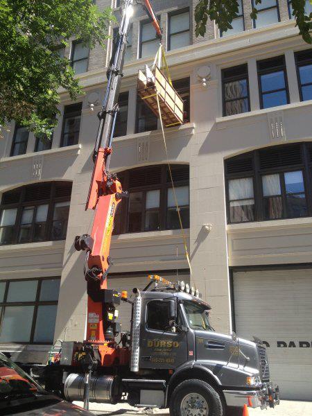 durso knuckleboom truck offloading at jobsite